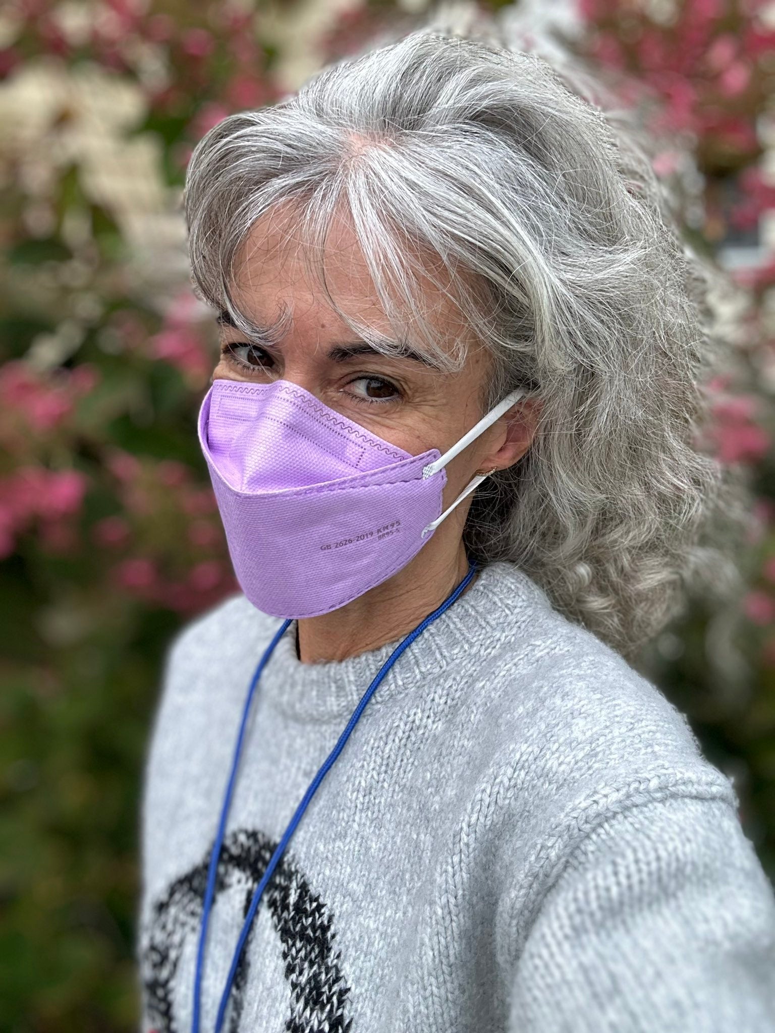 Woman wearing purple lavender BreatheTeq KN95 respirator face mask